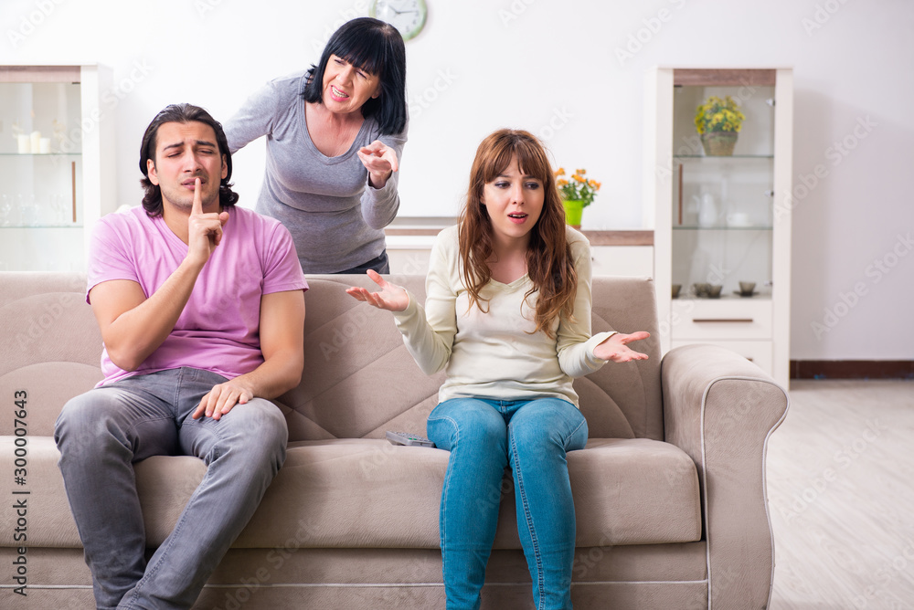Young family and mother-in-law in family issues concept Young family and mother-in-law in family issues concept