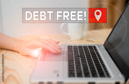 Conceptual hand writing showing Debt Free. Concept meaning does not owning any money to any individual or companies woman with laptop smartphone and office supplies technology