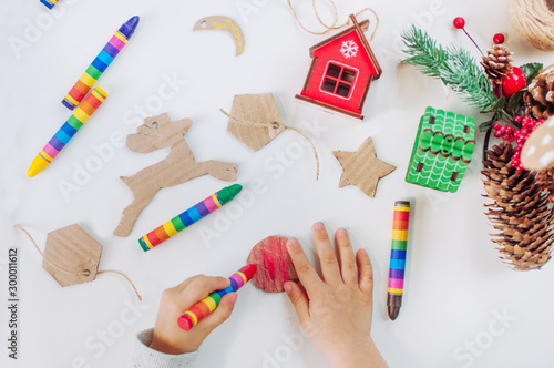 Close up of kids hands drawing handmade corrugated cardboard decorations