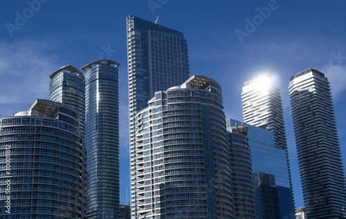 Toronto skyscrapers in front of deep blue sky.