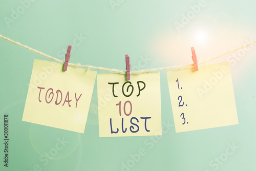 Writing note showing Top 10 List. Business concept for the ten most important or successful items in a particular list Clothesline clothespin rectangle shaped paper reminder white wood desk