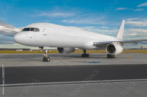 Cargo airplane parked at an airport, blank white body © Gudellaphoto