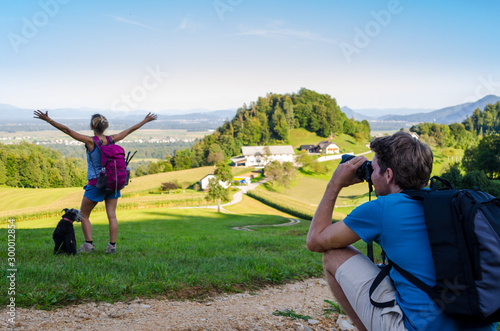 Professional photographer taking picture of a woman outdoors photo