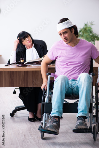 Disabled man consulting judge for damages litigation