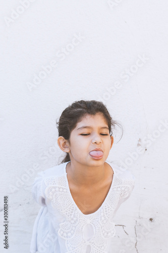Slika na platnu Little funny girl shows tongue