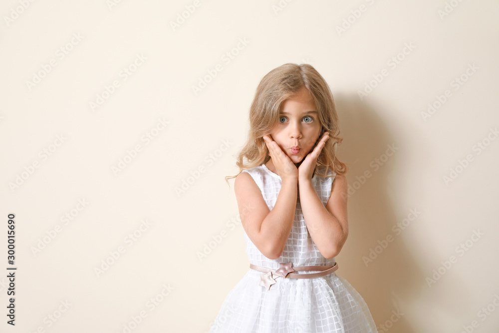 Grimacing little girl on light background Grimacing little girl on light background