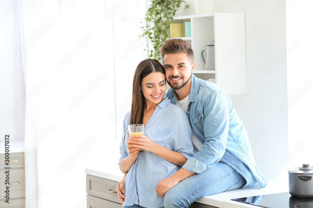 Happy young couple in kitchen at home Happy young couple in kitchen at home