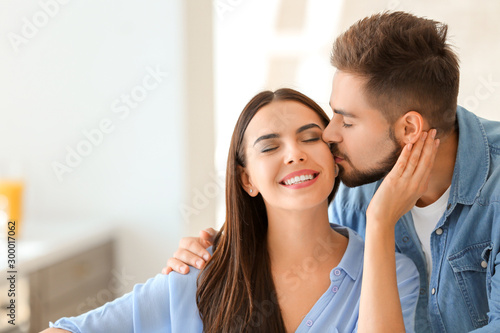Happy young couple in kitch...
