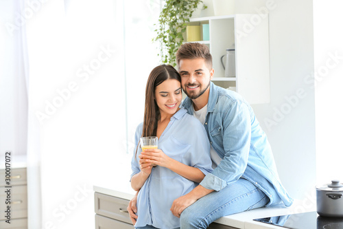 Happy young couple in kitch...