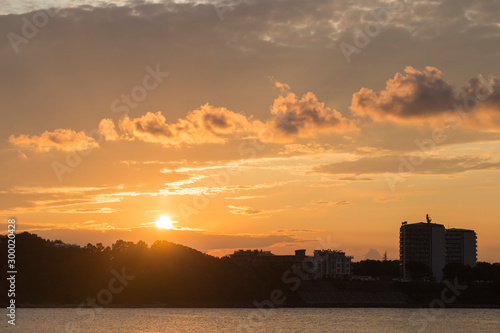 Sunset over the Black Sea in Bulgaria, place Kiten, Burgas Region. The sun sets over the horizon and is reflected in the water. Panorama.