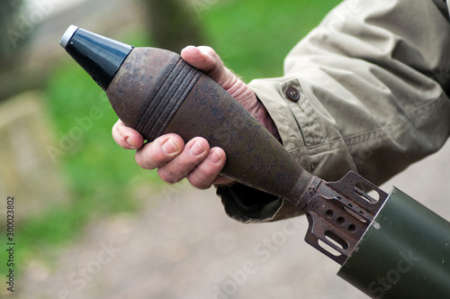 closeup of american soldier using a mortar shell during the world war two reconstitution for the 75 th anniversary of the liberation of Alsace in France