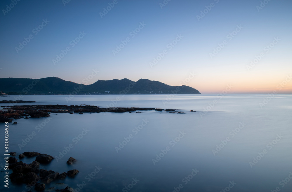 Sunrise near Cala Bona Mallorca with a silky flat sea giving a serene and enigmatic feel to the early morning.