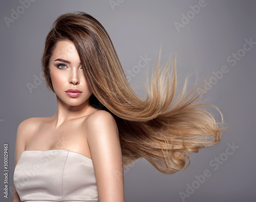 Young woman with long straight hair. Blond girl.
