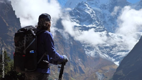 Active hiker hiking next toThamserku mountain in Nepal. Static handled shot, Travel sport lifestyle concept photo