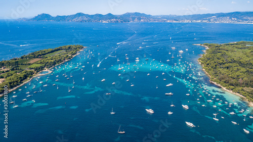 Aerial drone shot view of yachts between Ile Sainte Marguerite and Ile Saint Honorat in mediterranean sea