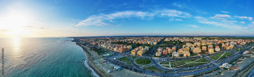Ostia beach aerial panoramic view from drone. Ostia Lido near Rome, Italy. Beautiful sea, coast and city view at sunset from above.