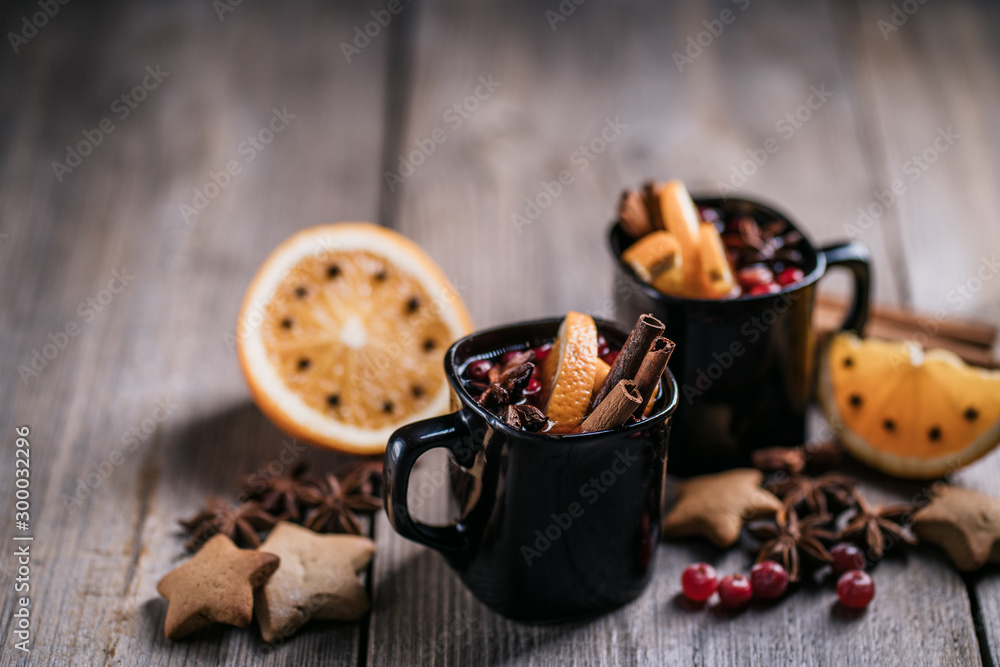 Christmas home atmosphere. Cozy and warming winter drink. Hot mulled wine, delightful festive sweets and spices Christmas home atmosphere. Cozy and warming winter drink. Hot mulled wine, delightful festive sweets and spices