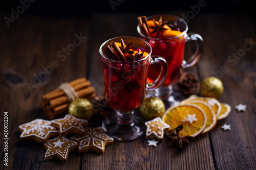 Christmas holidays atmosphere, cold winter day. Warming mood. Mulled wine with cranberry, cinnamon, orange and anise.