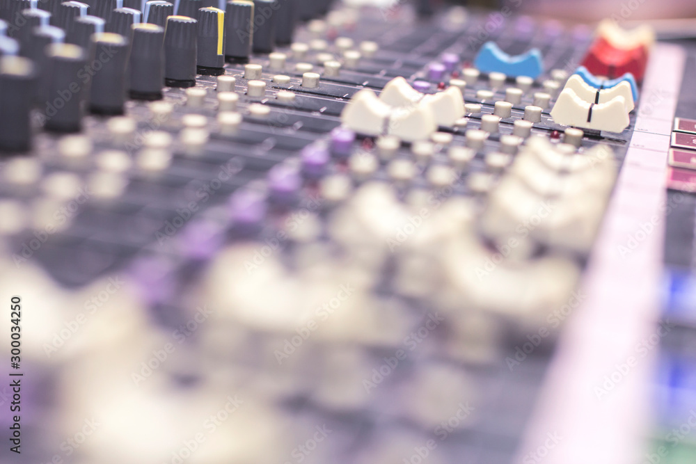 Obraz premium Slide the volume of the audio mixer on the console in the recording and editing work.