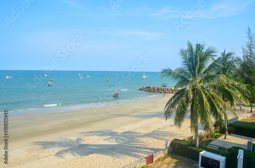 Fototapeta Naklejka Na Ścianę i Meble -  Exotic tropical vibrant coastal waterscape with palm trees in a blue sky over ocean water. Thailand.