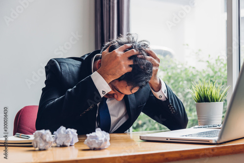 Asian young business man tired strain failure on he work photo
