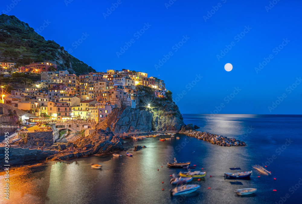 Long exposure view of Manarola with lights in the evening