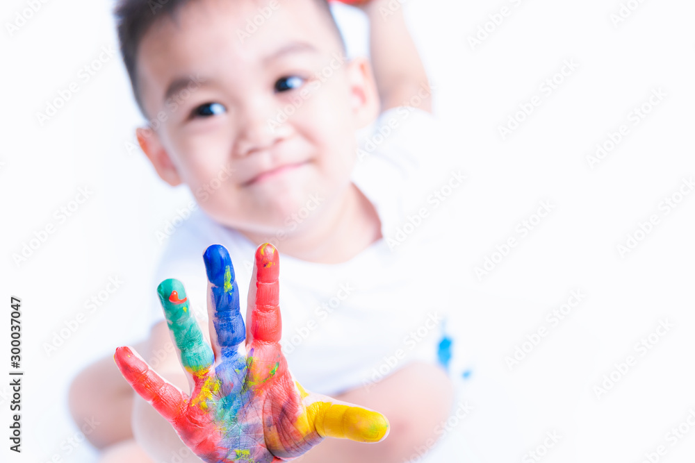 Happy asian childhood kid smile on education art he show hand with water color or finger paint on hands Happy asian childhood kid smile on education art he show hand with water color or finger paint on hands