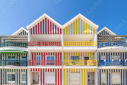 Street with colorful houses in Costa Nova, Aveiro, Portugal. Street with striped houses, Costa Nova, Aveiro, Portugal. Facades of colorful houses in Costa Nova, Aveiro, Portugal photo