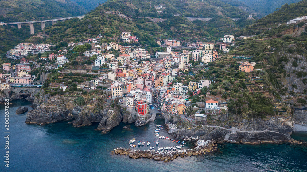 Aerial drone shot view of Riomaggiore village early morning in Cinque Terre, Italy