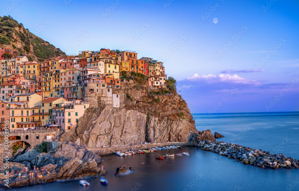 Long exposure shot of Manarola in Cinque Terre, Italy during sunset hours