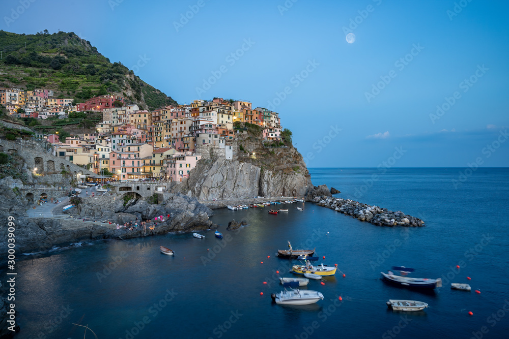Long exposure of Manrola before night with moon in cinque terra
