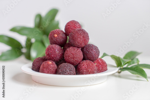 Sweet and sour red fruit bayberry, before a white color background