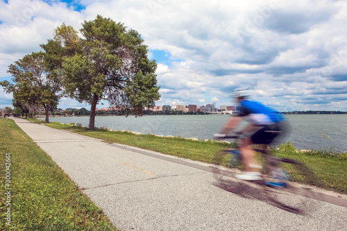Motion Blur of a person riding a bicycle past the capitol city of Wisconsin in Madison photo