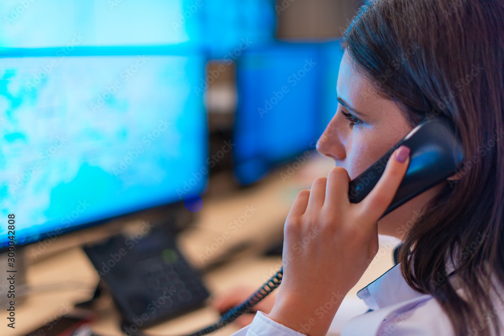 Female security guard operator talking on the phone Female security guard operator talking on the phone