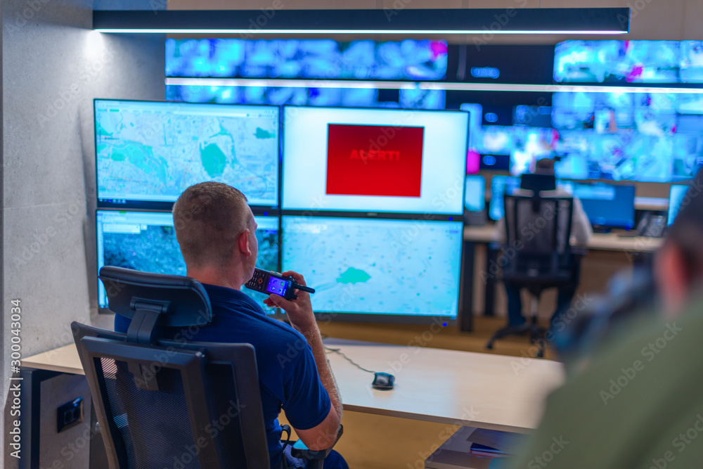 Male computer operator monitoring from a security ( computer, logistic ) center. Male computer operator monitoring from a security ( computer, logistic ) center.