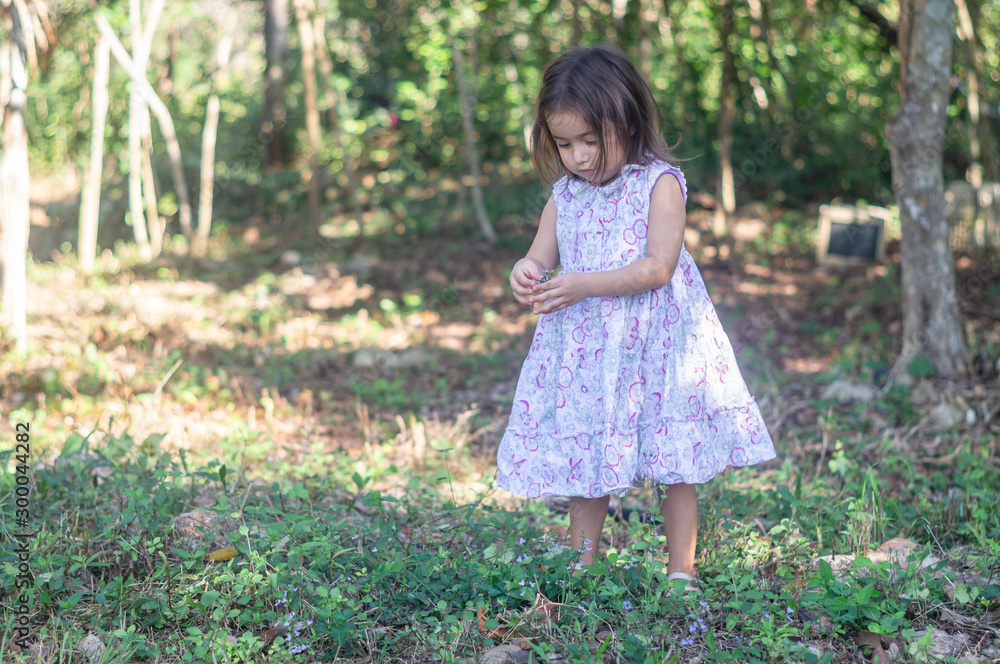 Three year old girl in the stone and weed field Three year old girl in the stone and weed field