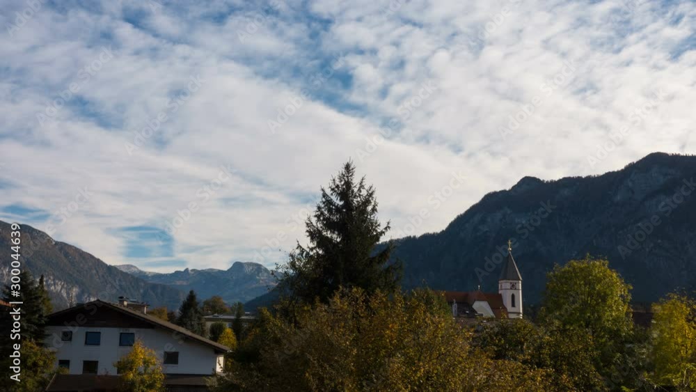 small church at the mountain austrian village with the clouds floating at the blue sky at sunny autumn day timelapse small church at the mountain austrian village with the clouds floating at the blue sky at sunny autumn day timelapse
