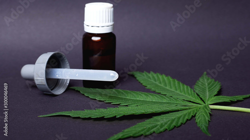 CBD and THC oil extract from medical marijuana and green leaf ,Concept: the medical use of cannabis to achieve a therapeutic effect in the treatment of cancer and epilepsy