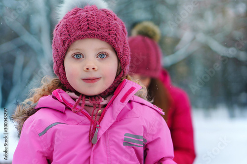 Closeup portrait, charming sweet, stylishly dressed child. Fashionable girl on a walk in winter. Relaxing outdoors. Ampaigns and adventures. Lifestyle concept.  photo