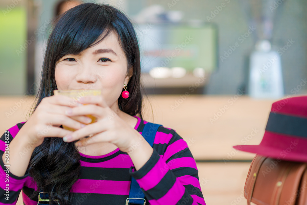 Woman drinking orange juice smiling Woman drinking orange juice smiling