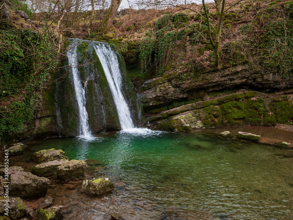 Fototapeta premium Janet's Fosses waterfall into a green gorge
