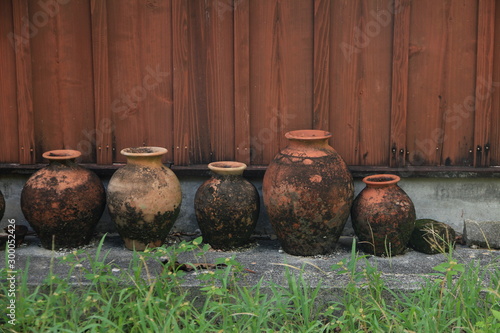 Okinawan (Ryukyuan) Pottery Placed outside a Wooden House