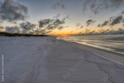 Fototapeta Naklejka Na Ścianę i Meble -  A View down Okaloosa Beach, Florida just before Sunrise
