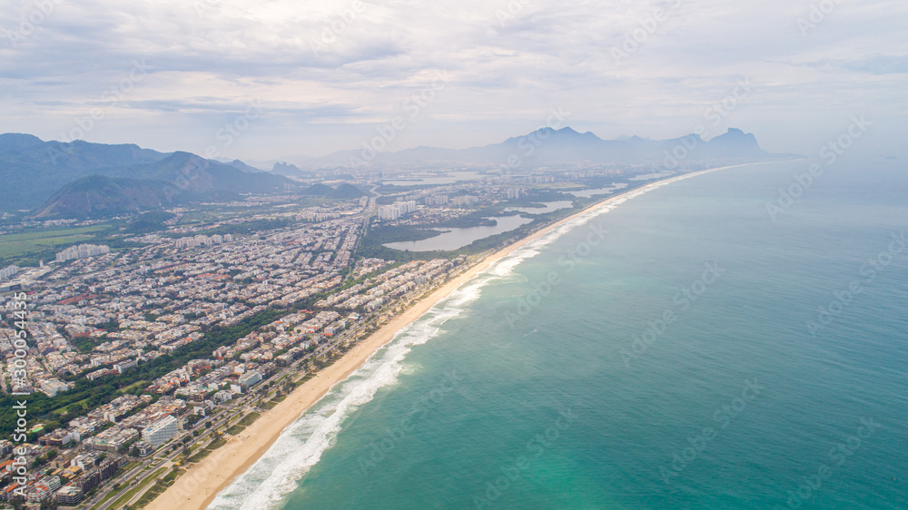 Tropical beach aerial view. Waves break on tropical yellow sand beach. Beautiful tropical beach aerial