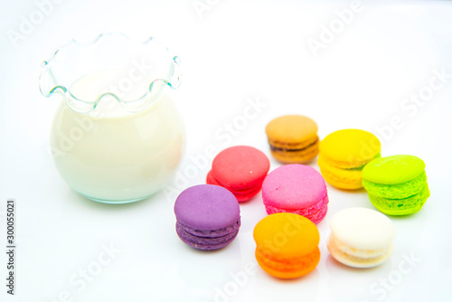 Cake macaron colourful macaroons and milk on a White background suitable for snacks  appropriate the background   idea copy space