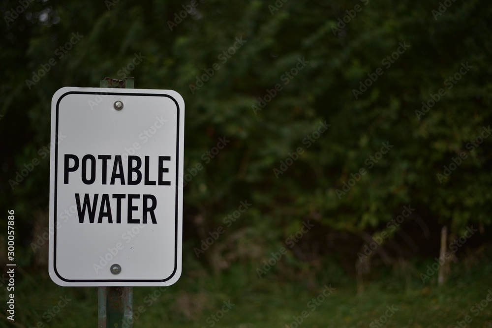 Potable Water sign with trees in background