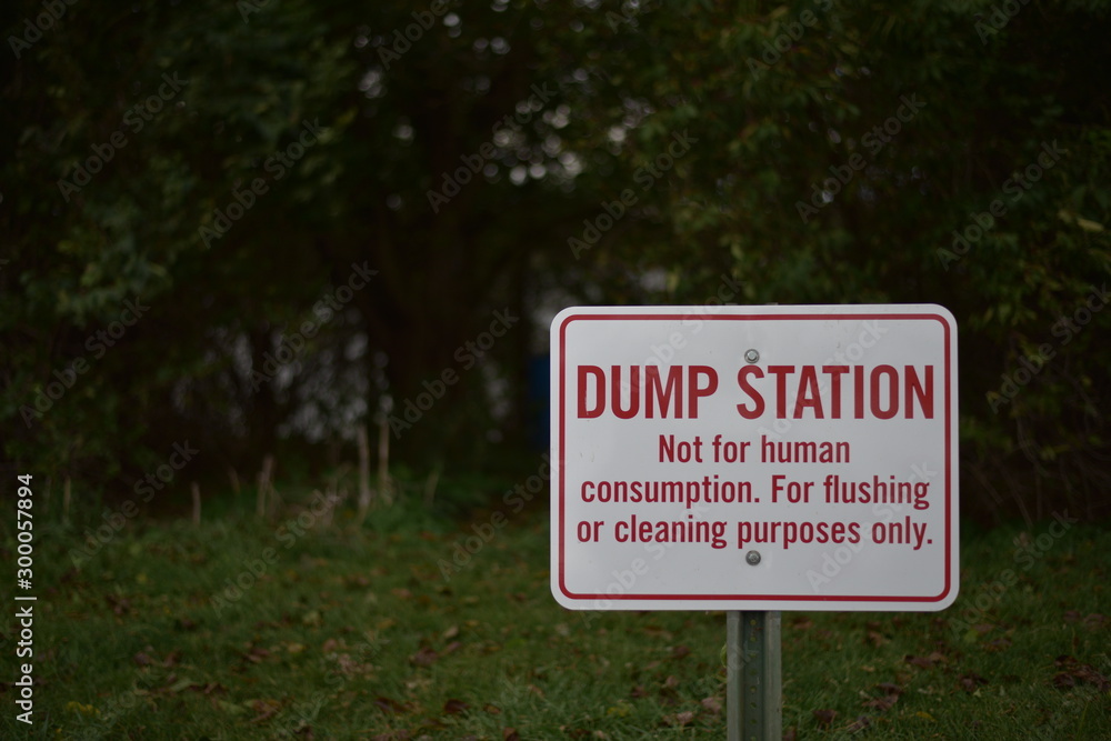 Dump Station sign with trees in background