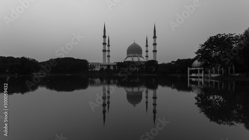 shah alam, malaysia mosque during sunrise with reflection from the lake