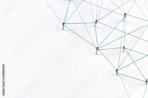A large grid of pins connected with string. Communication, technology, network concept. Network with pinsA large grid of pins connected with string. Communication, technology, network concept. 
