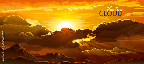The sun setting behind the clouds and rays of light shining in the evening.
